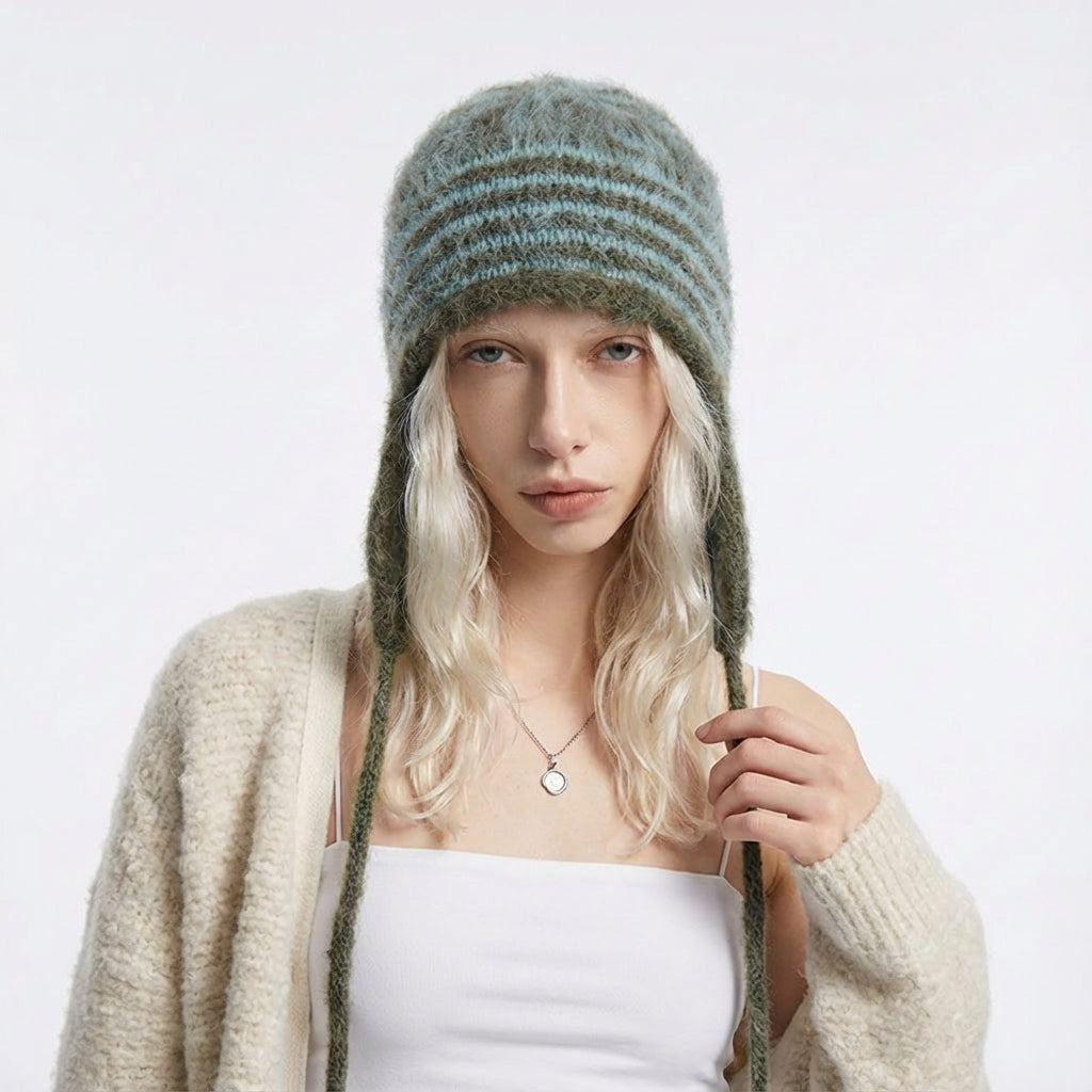 Model wearing the peacock green and olive green striped earflap hat.