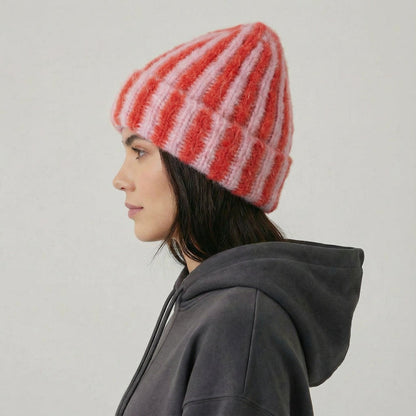 Side view of Model wearing Striped Fluffy Knit Beanie in pink, highlighting the thick, fluffy knit texture.