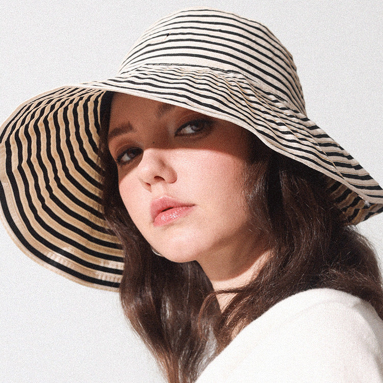 Model wearing Striped Wide Brim Bucket Hat in khaki black. Pure breathable cotton for outdoor leisure.
