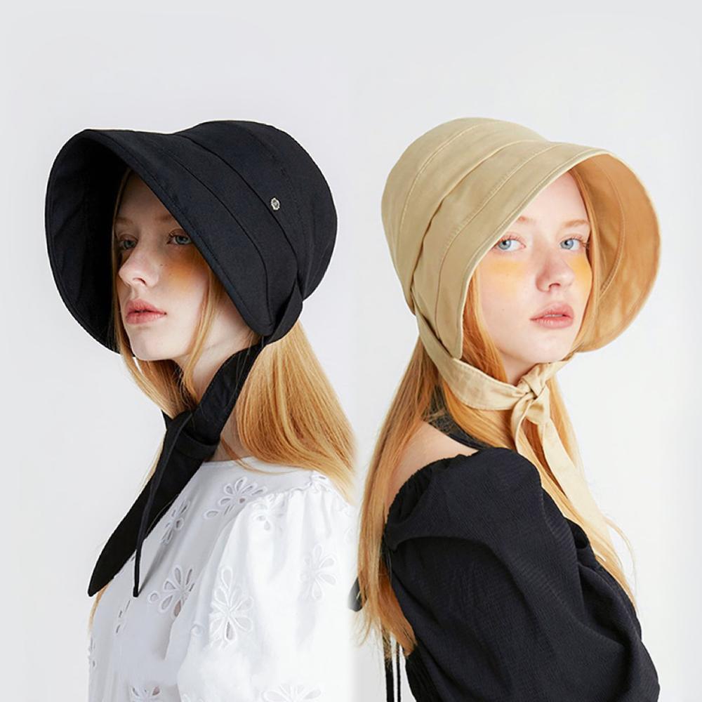 Side-by-side view of models wearing the Sun Shield Ribbon Bucket Hat in black and cream yellow.