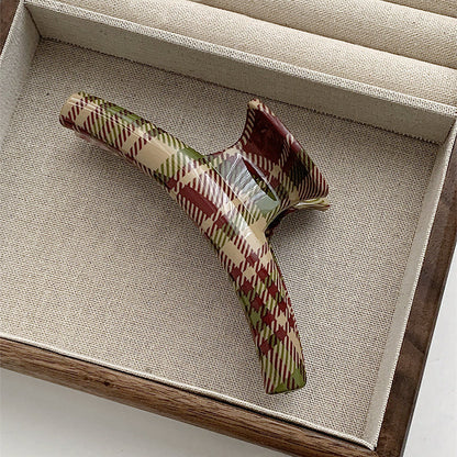 Angled view of  arc Tartan Elegance Hair Claw, great for everyday styling and gifting.