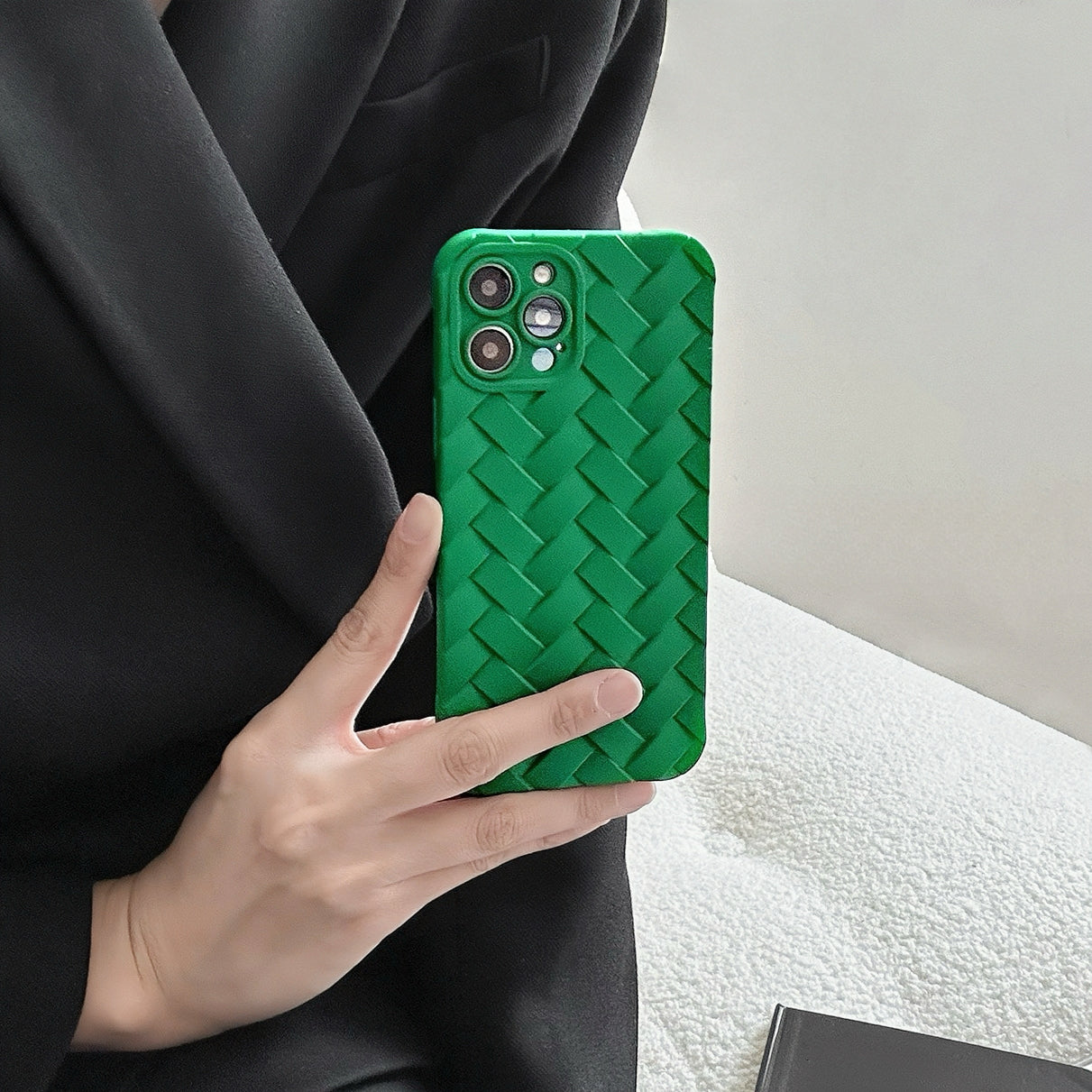 Model holding green Textured Woven Case. Intricate 3D woven-style texture on protective silicone.