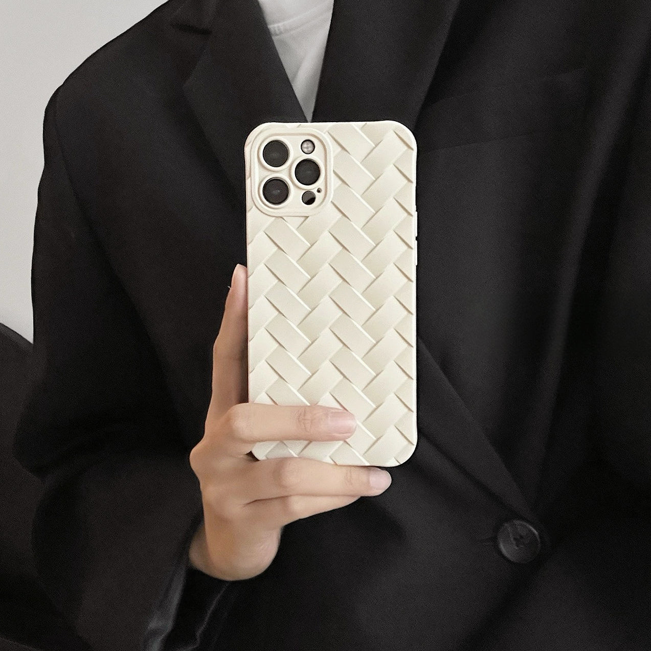 Model holding white Textured Woven Case. Elegant 3D woven pattern on a flexible, durable frame.