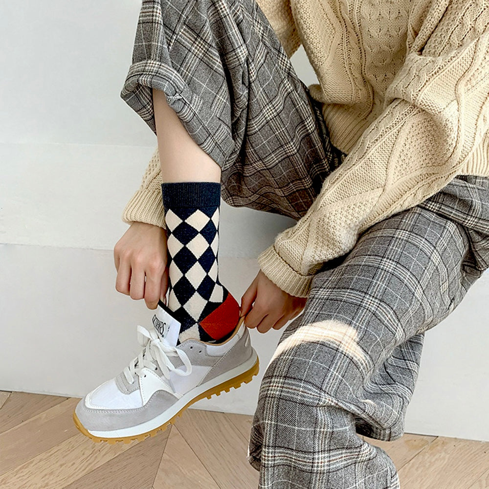 Model wearing a pair of Thick Retro Socks in checkered pattern, easy to pack for travel and errands.