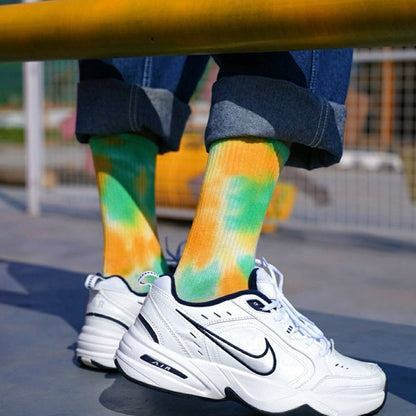 Model wearing a pair of green and gold tie-dye cotton socks, great for casual wear and light workouts.