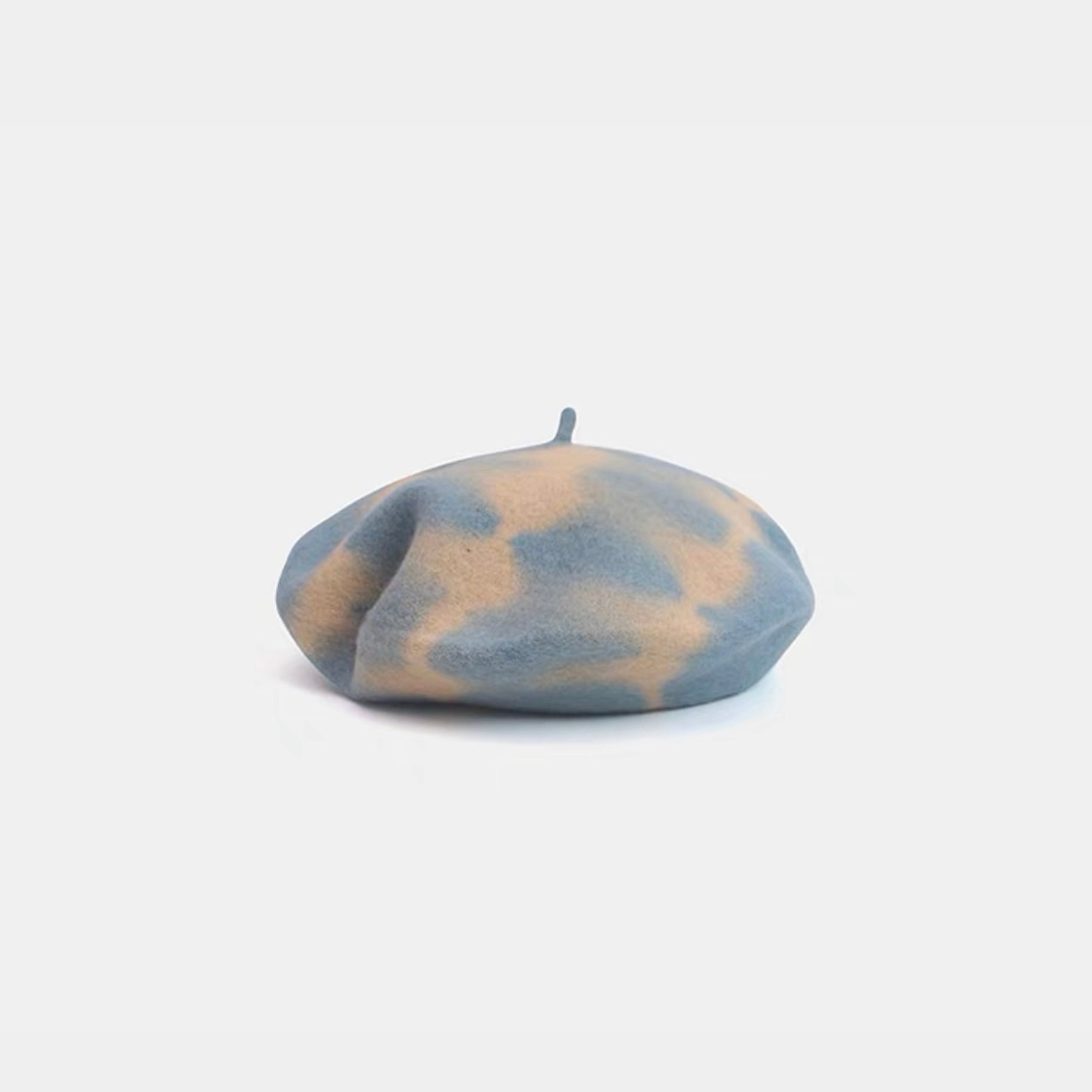 Light blue and beige tie-dye wool beret displayed on a white background.