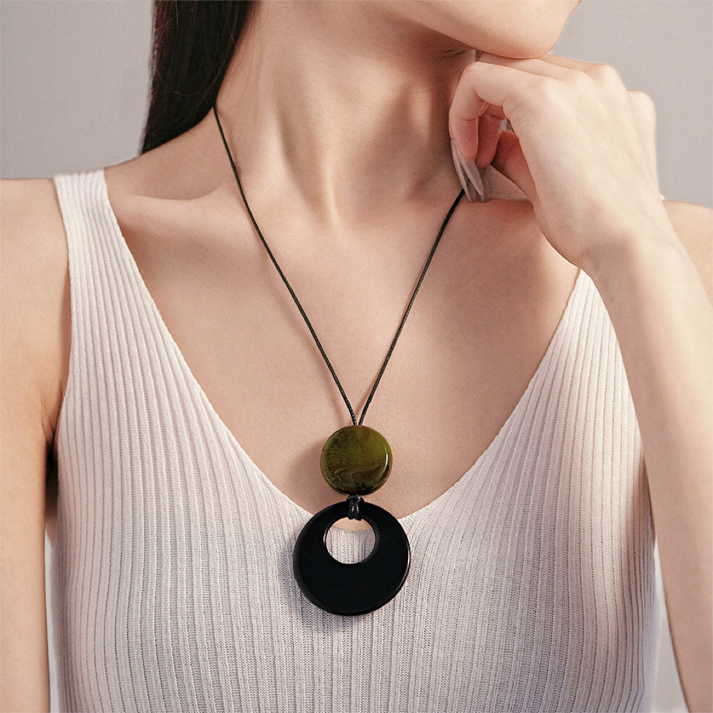 Model wearing a Twilight Loop Necklace in Black Green, ideal for date nights.