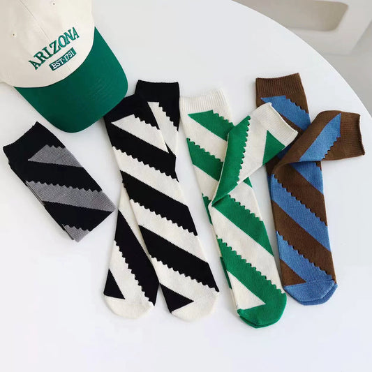 Front view of Four pairs of twill cutout socks in black, green, brown and blue.