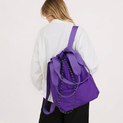 Model styled with the purple ultralight 2-way convertible nylon backpack.