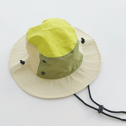 Close-up of the olive green and beige ultralight brimmed hat with windproof cord.
