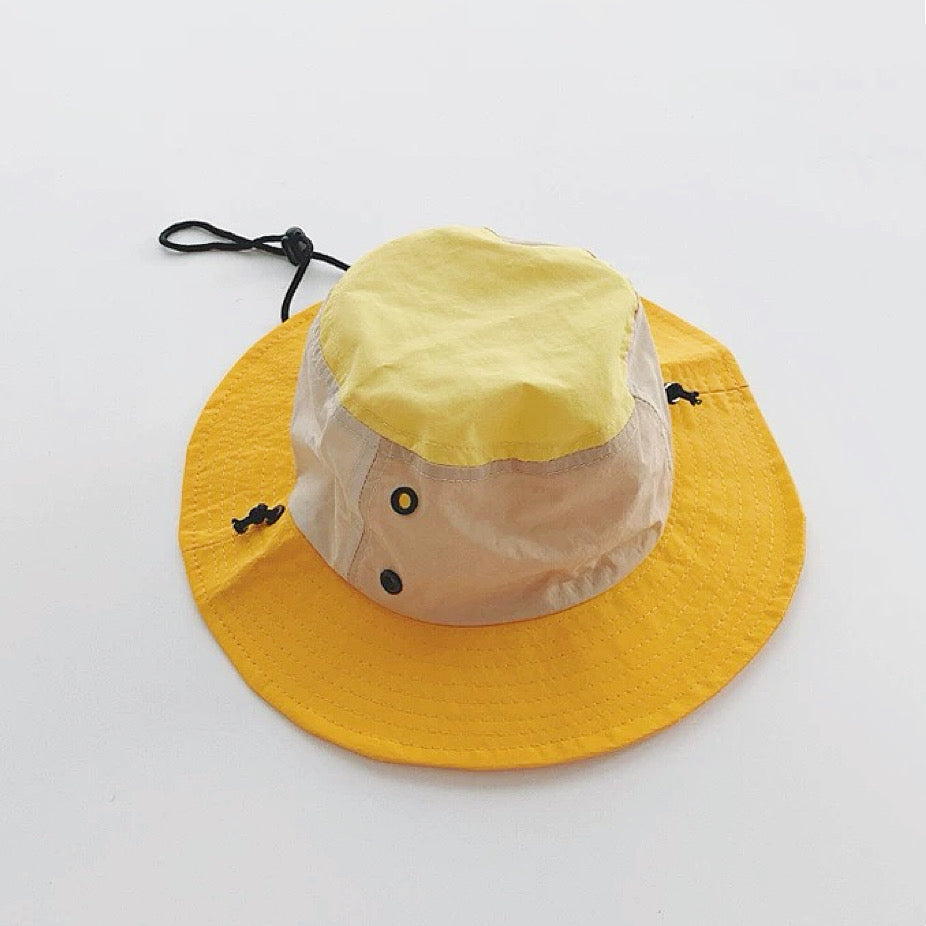 Yellow and musturd version of the plant-inspired brimmed hat displayed flat.