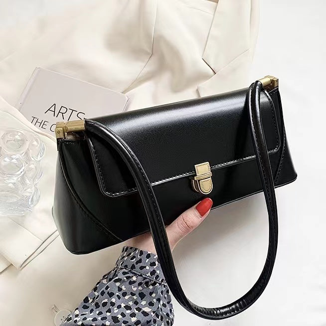 Model holding a black  Vintage Baguette Bag in hand , ideal for city walks and gifting.