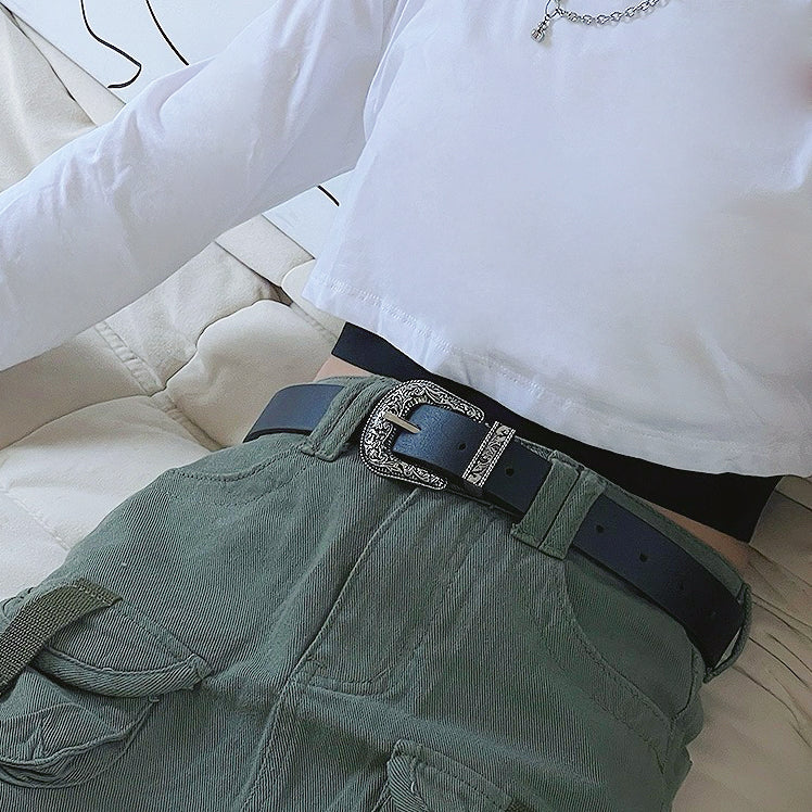 Black PU leather belt with an ornate vintage silver buckle, worn with green cargo pants.