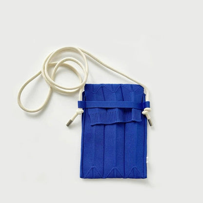 Folded view of Vivid Knit Pleat Mini Bag in cobalt blue, great for everyday carry and travel.