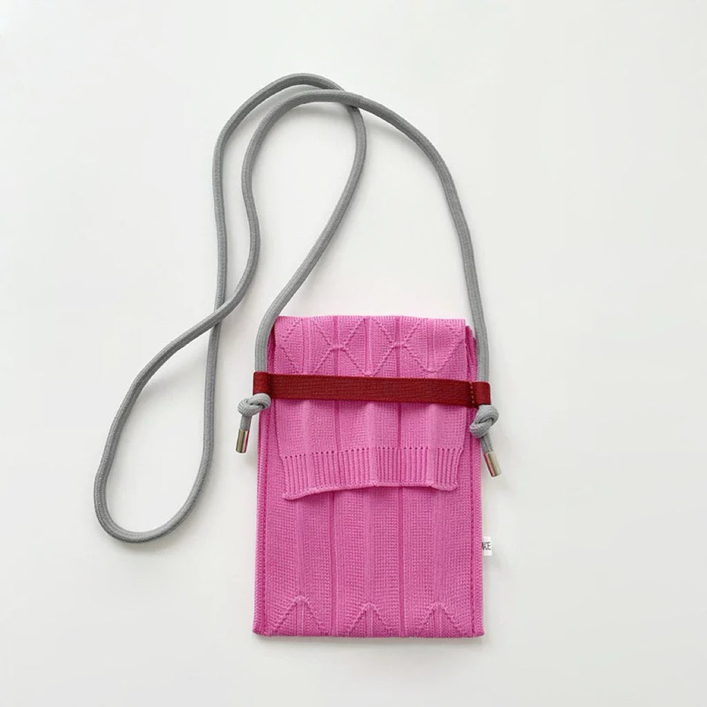 Folded view of Vivid Knit Pleat Mini Bag in pink, easy for commuting and weekends.