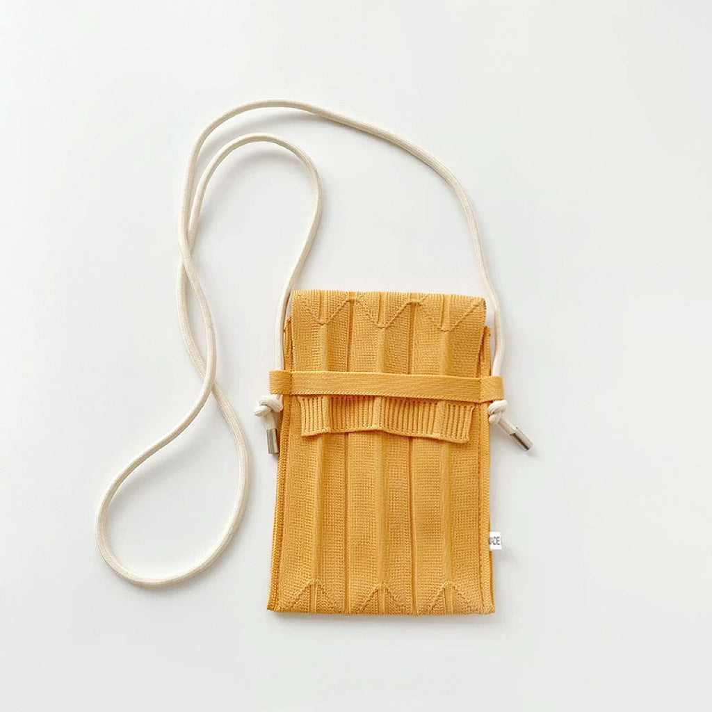 Flat lay of Vivid Knit Pleat Mini Bag in yellow, ideal for errands and gifting.