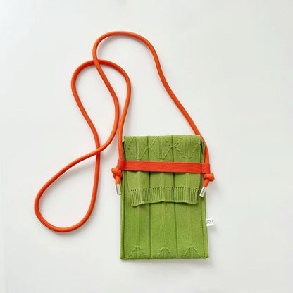 Angled view of Vivid Knit Pleat Mini Bag in green and yellow, great for everyday carry and travel.