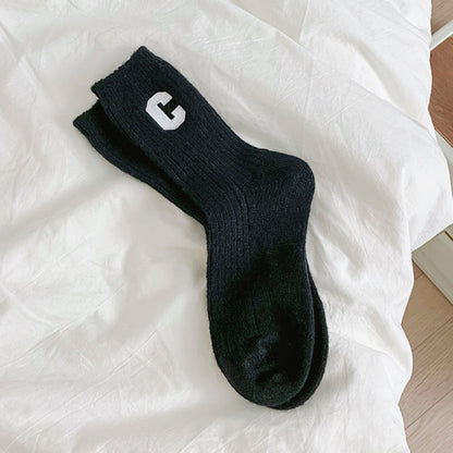 Angled view of Wool C Socks in black, great for daily wear and lounging.
