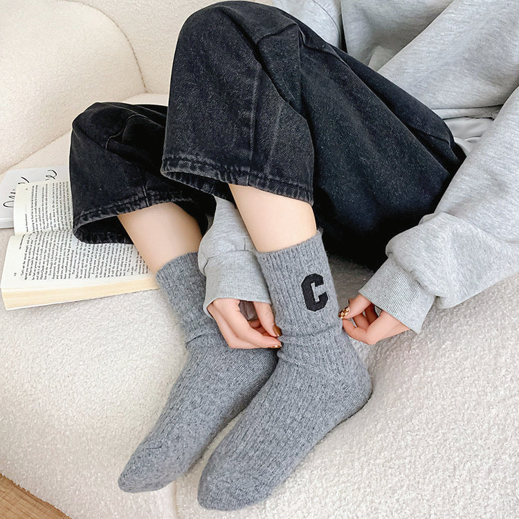 Model wearing a pair of gray wool socks, easy for travel days and daily comfort.
