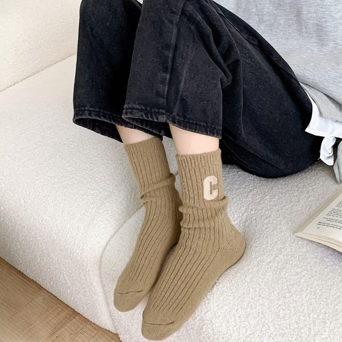 Model wearing a pair of khaki wool socks, easy for travel days and daily comfort.